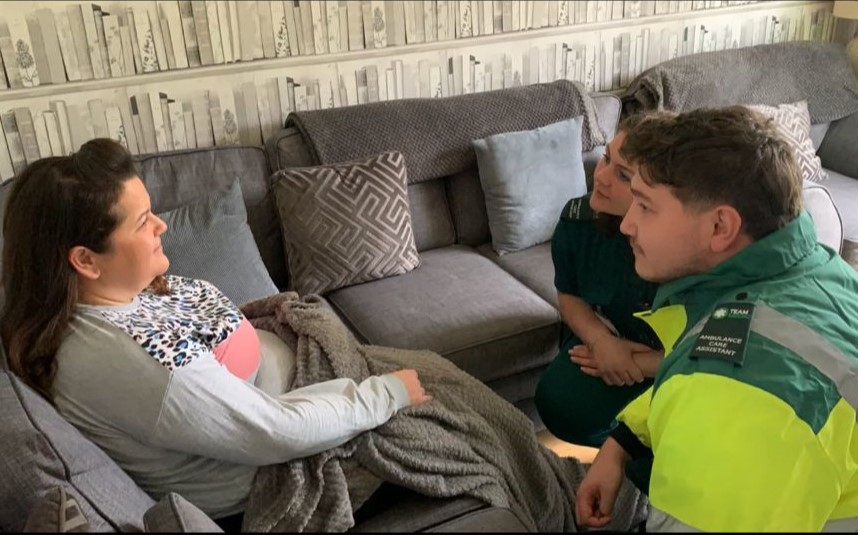 Medics assisting a patient with mobility challenges