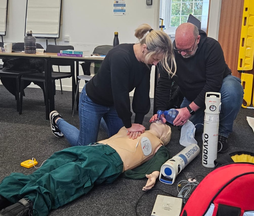 Team Medic instructor demonstrating how to do CPR on a training manikin